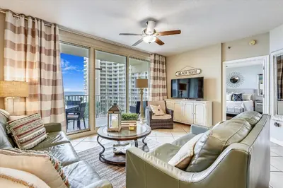 a living room with a couch and a table at Shores of Panama 620-Sleeps 8, Free Fun! Reserved Parking Space! Updated! condo in Panama City Beach