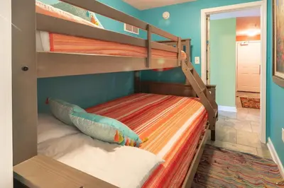 a bunk bed in a room with two bunk beds at Shores of Panama 621-Sleeps 8, Free Beach Fun! Reserved Parking Space! condo in Panama City Beach