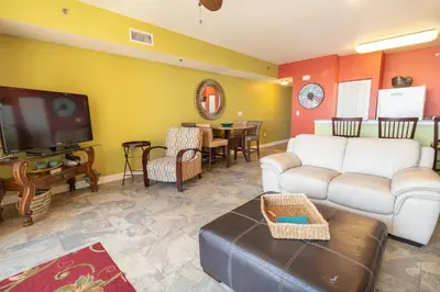 a living room with a couch and a tv at Shores of Panama 621-Sleeps 8, Free Beach Fun! Reserved Parking Space! condo in Panama City Beach
