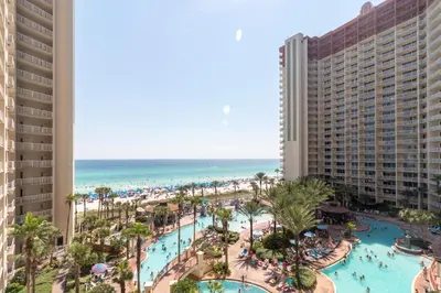 a view of the beach from the balcony of a resort at Shores of Panama 621-Sleeps 8, Free Beach Fun! Reserved Parking Space! condo in Panama City Beach
