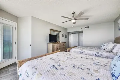 a bedroom with two beds and a ceiling fan at Long Beach Tower 3, #1303 - Completely Renovated 2 Bedroom Sleeps 8, condo in Panama City Beach
