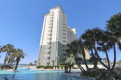 aominium building with palm trees and a swimming pool at Long Beach Tower 3, #1303 - Completely Renovated 2 Bedroom Sleeps 8, condo in Panama City Beach