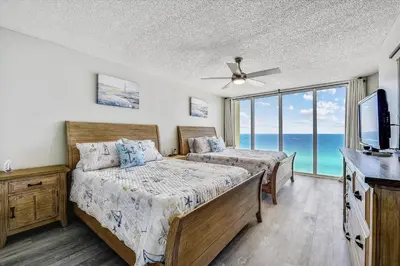 a bedroom with two beds and a flat screen tv at Long Beach Tower 3, #1303 - Completely Renovated 2 Bedroom Sleeps 8, condo in Panama City Beach