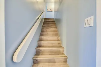 a staircase in a house with wooden floors at Recently renovated 2Bd, Sleeps 6 Pinnacle Port, with Boat Ramp condo in Panama City Beach