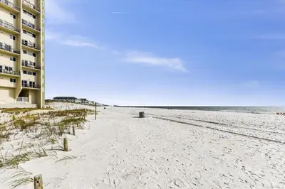 a view of a beach with a building and the ocean at Recently renovated 2Bd, Sleeps 6 Pinnacle Port, with Boat Ramp condo in Panama City Beach