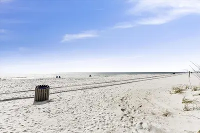 a trash can sitting on a sandy beach at Recently renovated 2Bd, Sleeps 6 Pinnacle Port, with Boat Ramp condo in Panama City Beach