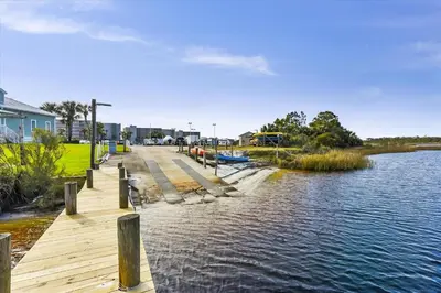 a wooden dock next to a body of water at Recently renovated 2Bd, Sleeps 6 Pinnacle Port, with Boat Ramp condo in Panama City Beach