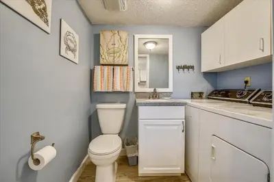 a bathroom with a toilet and a sink at Recently renovated 2Bd, Sleeps 6 Pinnacle Port, with Boat Ramp condo in Panama City Beach
