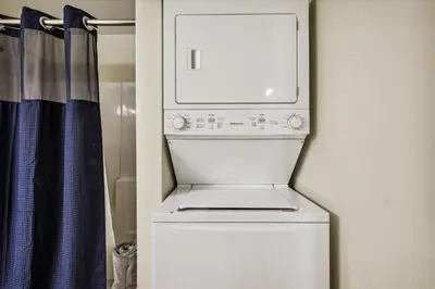 a white washer and dryer in a room at Shores of Panama 316 - 3rd Floor 1 Bedroom, Sleeps 6, Reserved Parking Space, Free Daily Fun! condo in Panama City Beach