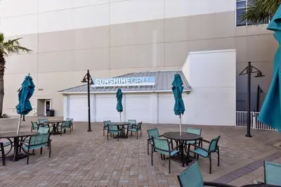 a group of tables and chairs with umbrellas at Laketown Wharf 1003, Gulf View, Sleeps 6, Free Fun! Updated! condo in Panama City Beach