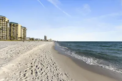a beach with condos in the background and the ocean at Laketown Wharf 1003, Gulf View, Sleeps 6, Free Fun! Updated! condo in Panama City Beach
