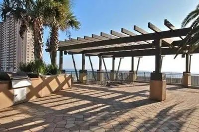 a pavilion with palm trees and the ocean in the background at Origin 1038, Sunset & Gulf View! Perfect for 2! Free Fun! condo in Panama City Beach