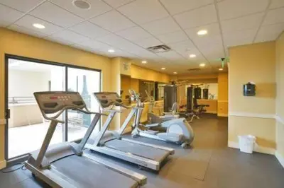 a gym with three tread machines in a room at Origin 1038, Sunset & Gulf View! Perfect for 2! Free Fun! condo in Panama City Beach