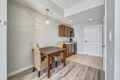 a kitchen with a wooden table and chairs at Origin 1038, Sunset & Gulf View! Perfect for 2! Free Fun! condo in Panama City Beach