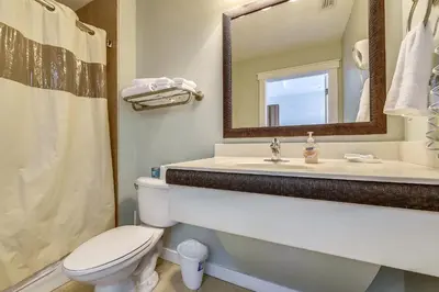 a bathroom with a sink and a toilet and a mirror at Origin 1038, Sunset & Gulf View! Perfect for 2! Free Fun! condo in Panama City Beach