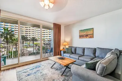 a living room with a couch and a table at Shores of Panama 325 - 3rd Floor, Updated, Free Fun! Sleeps 6, condo in Panama City Beach