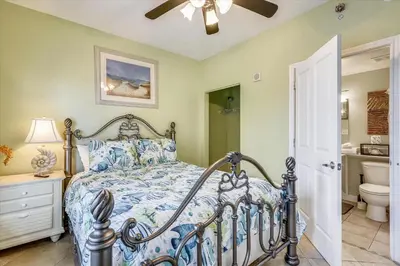 a bedroom with a bed and a ceiling fan at Shores of Panama 204 - 2nd Floor 2 Bedroom Sleeps 8, Same Floor Reserved Parking, Free Fun condo in Panama City Beach