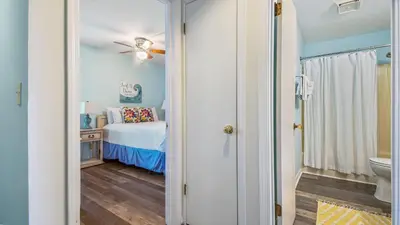 a small bedroom with a bed and a bathroom at Endless Summer #C4 by Nautical Properties Vacation Rentals in Panama City Beach