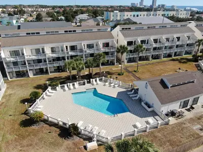 an aerial view of a building with a swimming pool at Endless Summer #C4 by Nautical Properties Vacation Rentals in Panama City Beach