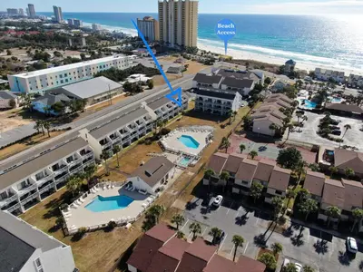 an aerial view of a city with a building and the ocean at Endless Summer #C4 by Nautical Properties Vacation Rentals in Panama City Beach