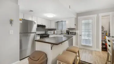 a kitchen with white cabinets and a refrigerator at Compass Cove at Gulf Highlands by Nautical Properties Vacation Rentals in Panama City Beach