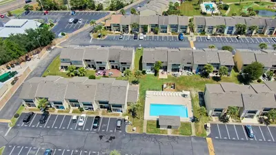 an aerial view of a parking lot with a pool at Compass Cove at Gulf Highlands by Nautical Properties Vacation Rentals in Panama City Beach