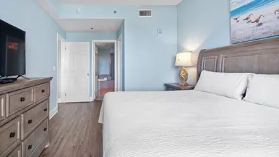 a bedroom with a large bed and a television at Laketown Wharf #101 by Nautical Properties Vacation Rentals in Panama City Beach