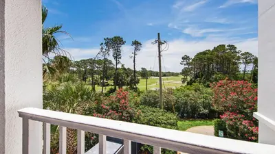 a balcony with a view of a golf course at Laketown Wharf #101 by Nautical Properties Vacation Rentals in Panama City Beach