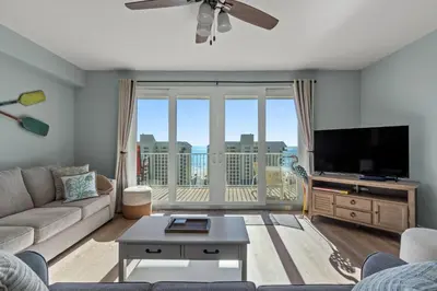 a living room with a couch and a flat screen tv at Living Right at Laketown Wharf #1016 by Nautical Properties in Panama City Beach