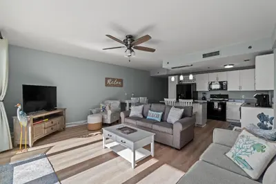 a living room with a couch and a table at Living Right at Laketown Wharf #1016 by Nautical Properties in Panama City Beach