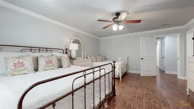 a bedroom with a bed and a ceiling fan at Private Pool - Steps To Beach - Fenced Backyard - FLPCB74 in Panama City Beach