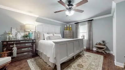 a bedroom with a white bed and a ceiling fan at Private Pool - Steps To Beach - Fenced Backyard - FLPCB74 in Panama City Beach