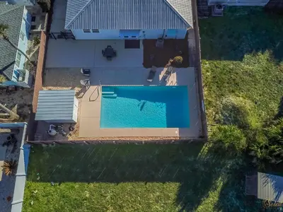 an overhead view of a swimming pool in a yard at Private Pool - Steps To Beach - Fenced Backyard - FLPCB74 in Panama City Beach