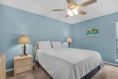 a bedroom with a bed and a ceiling fan at Horizon South 51B in Panama City Beach