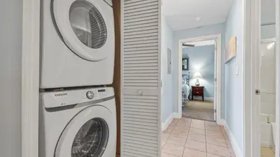 a white washer and dryer in a hallway at Laketown Wharf #1211 by Nautical Properties Vacation Rentals in Panama City Beach