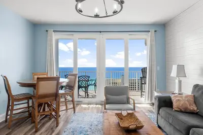 a living room with a view of the ocean at Stunning Ocean Views! Resort Beach Condo! Sleeps 8! by Dolce Vita Getaways PCB in Panama City Beach