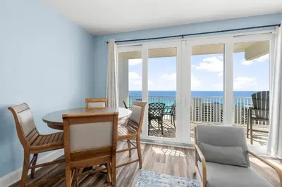 a dining room with a view of the ocean at Stunning Ocean Views! Resort Beach Condo! Sleeps 8! by Dolce Vita Getaways PCB in Panama City Beach