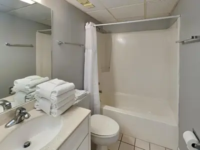 a bathroom with a sink and a toilet and a shower at Edgewater Leeward #206 in Panama City Beach