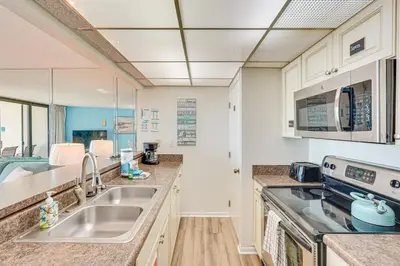 a kitchen with a sink and a stove at PCB Vacation Rental with Sweeping Ocean Views! in Panama City Beach