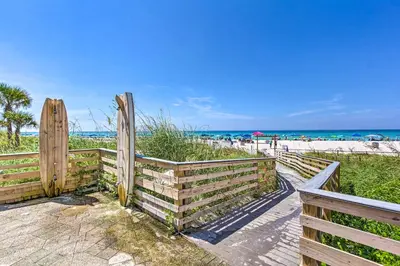 a wooden fence at the beach with the ocean in the background at PCB Vacation Rental with Sweeping Ocean Views! in Panama City Beach