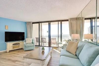 a living room with a couch and a tv at PCB Vacation Rental with Sweeping Ocean Views! in Panama City Beach