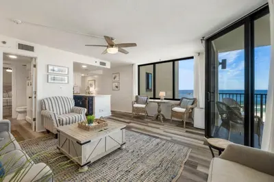 a living room with a view of the ocean at Sunbird Resort! Direct Beachfront Condo! Free Beach Chairs! by Dolce Vita Getaways PCB in Panama City Beach