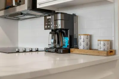 a coffee maker on a counter in a kitchen at Sunbird Resort! Direct Beachfront Condo! Free Beach Chairs! by Dolce Vita Getaways PCB in Panama City Beach