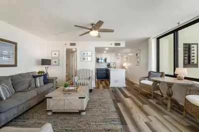 a living room with a couch and a table at Sunbird Resort! Direct Beachfront Condo! Free Beach Chairs! by Dolce Vita Getaways PCB in Panama City Beach