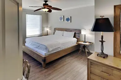 a bedroom with a bed and a ceiling fan at Grandview East #703 in Panama City Beach