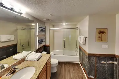 a bathroom with a sink and a toilet and a shower at Grandview East #703 in Panama City Beach
