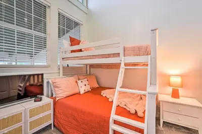 a bedroom with two bunk beds and a desk at Pool and Beach Access Sunnyside 55 in PCB! in Panama City