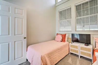 a bedroom with a bed and a flat screen tv at Pool and Beach Access Sunnyside 55 in PCB! in Panama City
