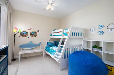 a childs room with a bunk bed and a crib at Water Park On-Site! 2 Beachfront Master Suites! Corner Balcony Views! in Panama City Beach