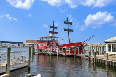 a red boat is docked at a dock at Beautiful Ocean Views! 2-Bedroom, 2-Bathroom! Resort Pools! in Panama City Beach